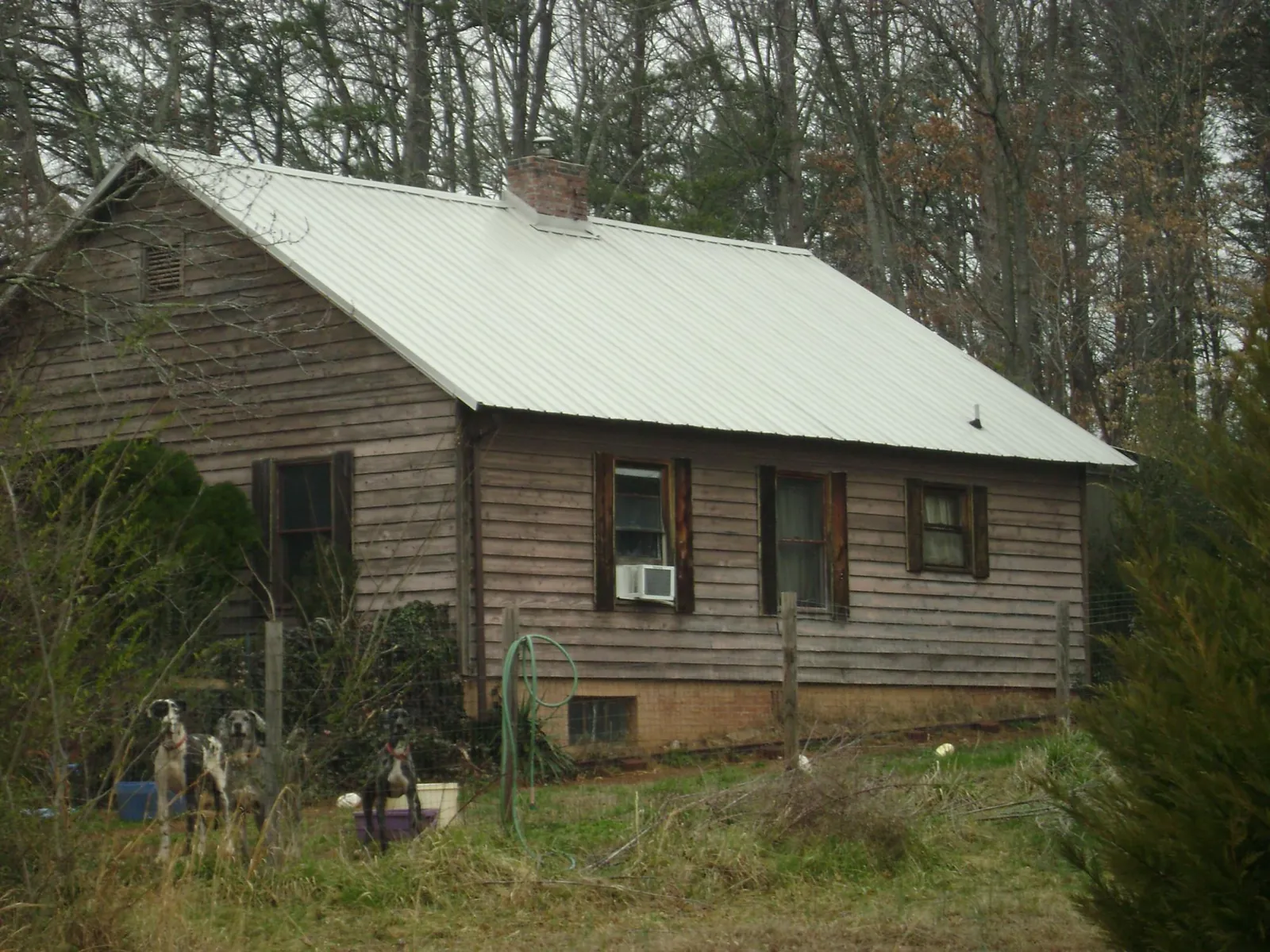 White metal roof on an old wood sided farmhouse, from a Metal Roof Installation job in Glasco